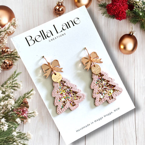 Bella Lane creations earrings on a white card with Christmas decorations around